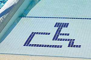 Accessible swimming pool with wheelchair symbol.
