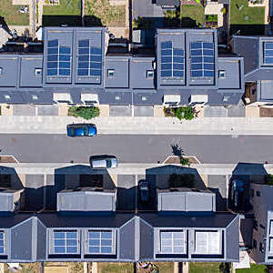 Overhead aerial view of a newly built housing development with solar panels installed in all the homes 