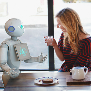 Pepper the robot and a young woman chatting